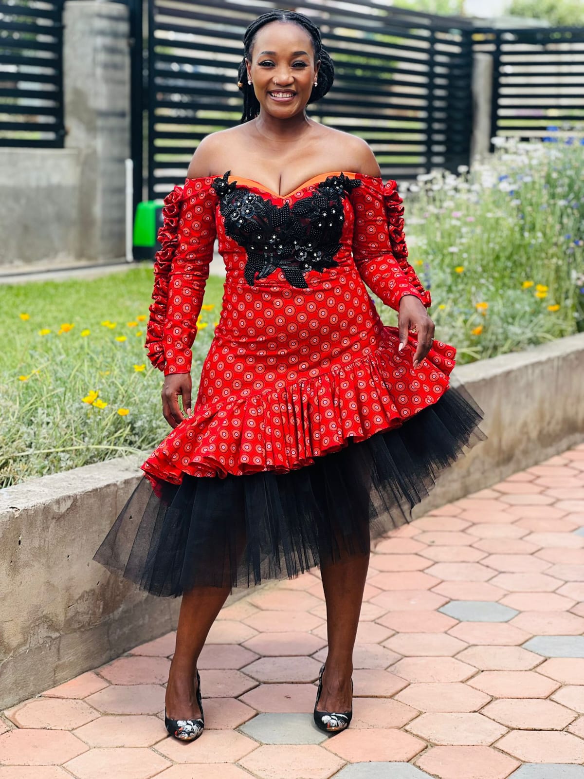 Jane.M red Seshoeshoe traditional dress with black tulle and floral bodice detail in Lesotho